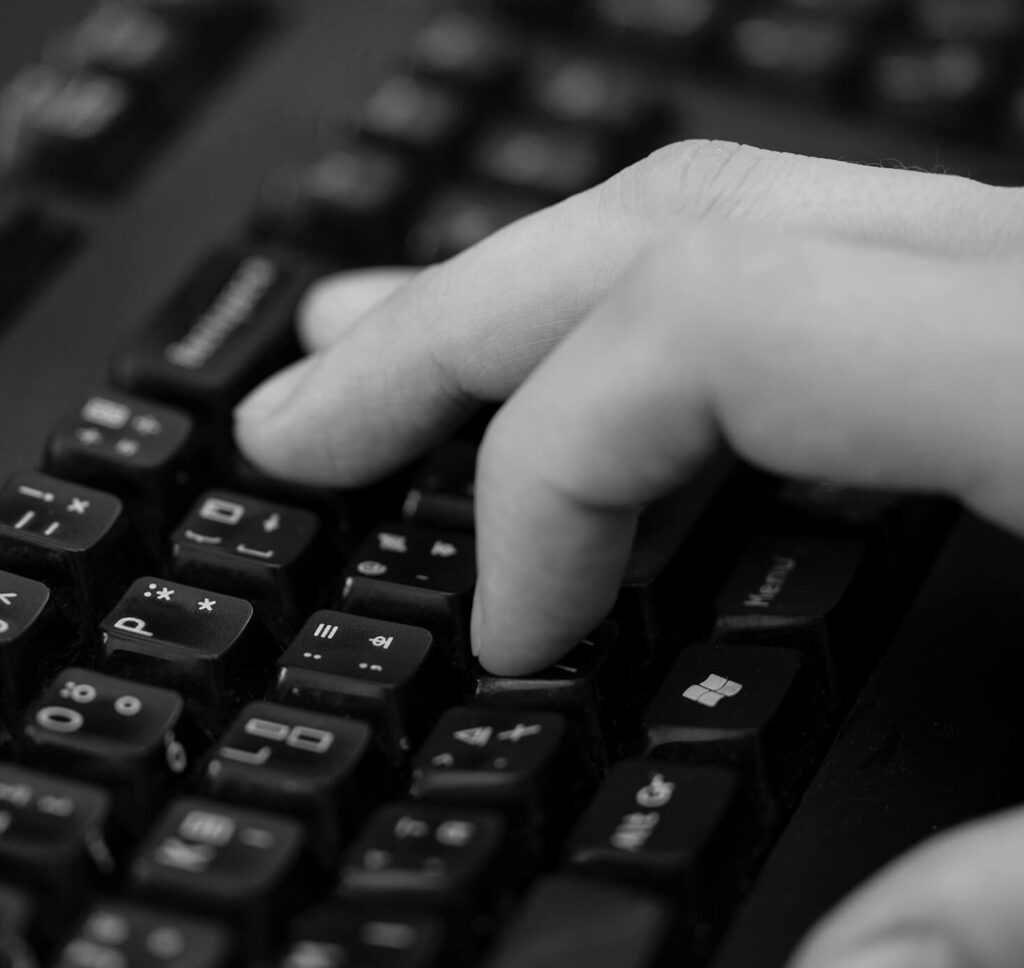 Fingers typing on keyboard
